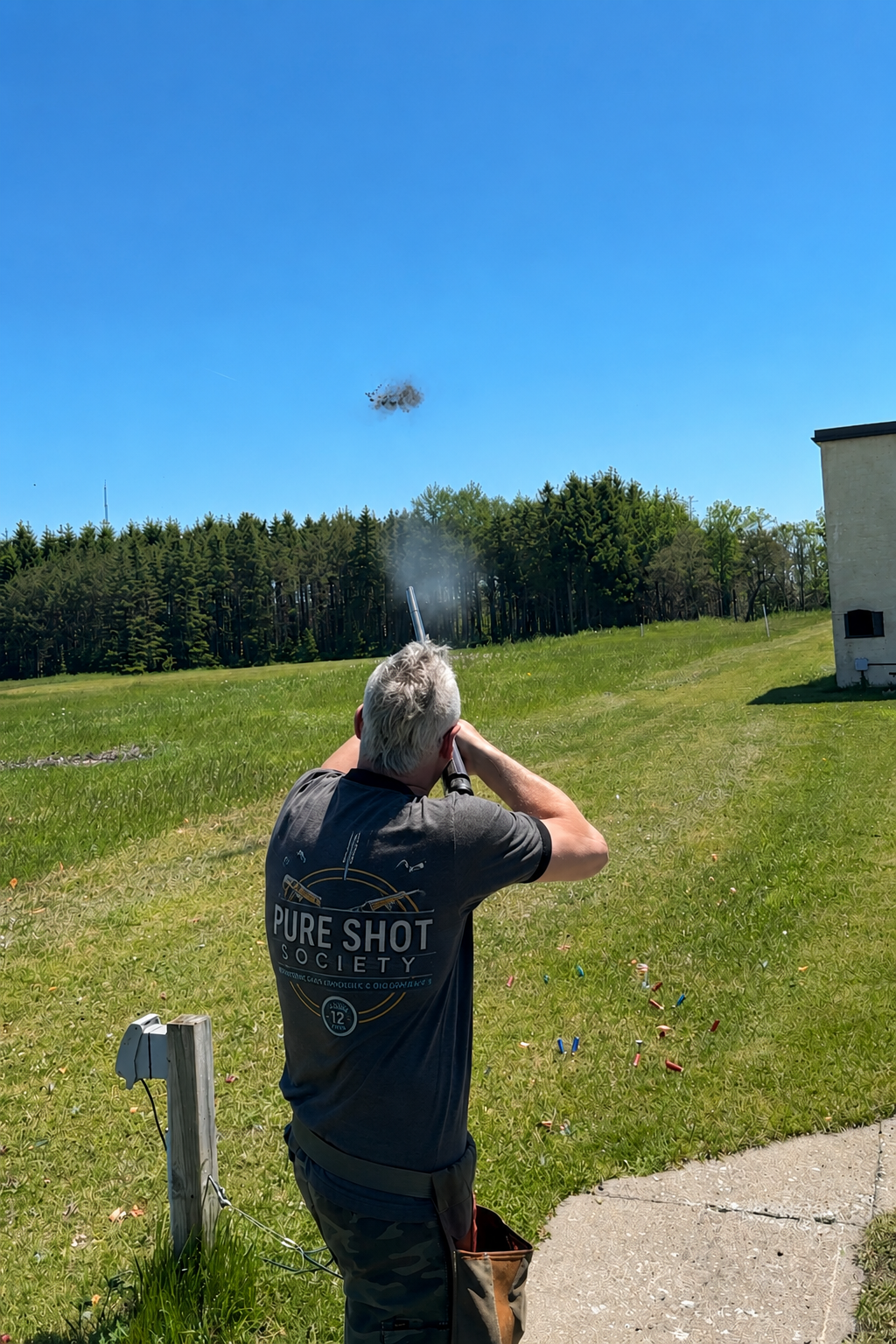 Shooter breaking a clay at the range