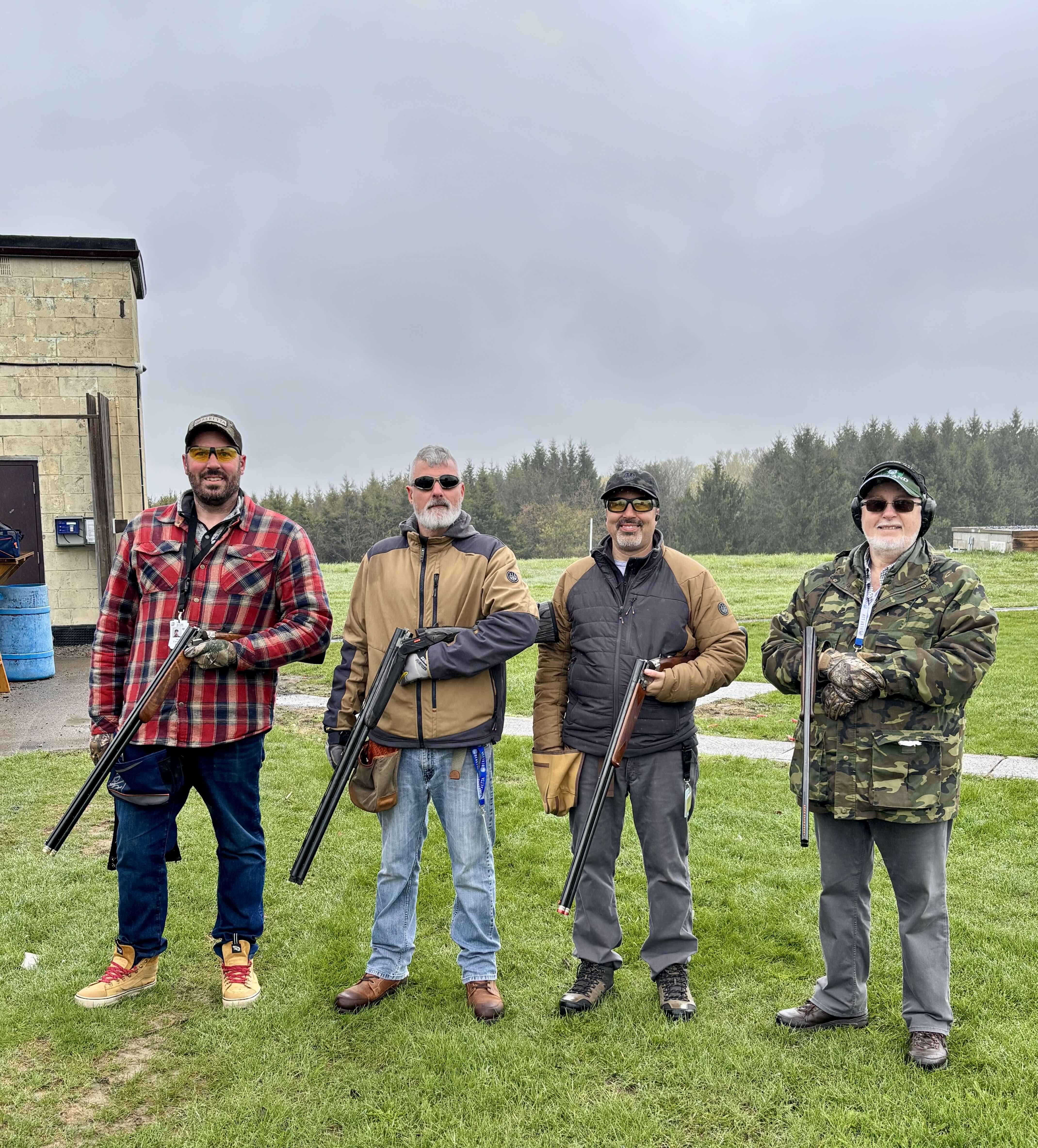 Four shooters standing together after a range day