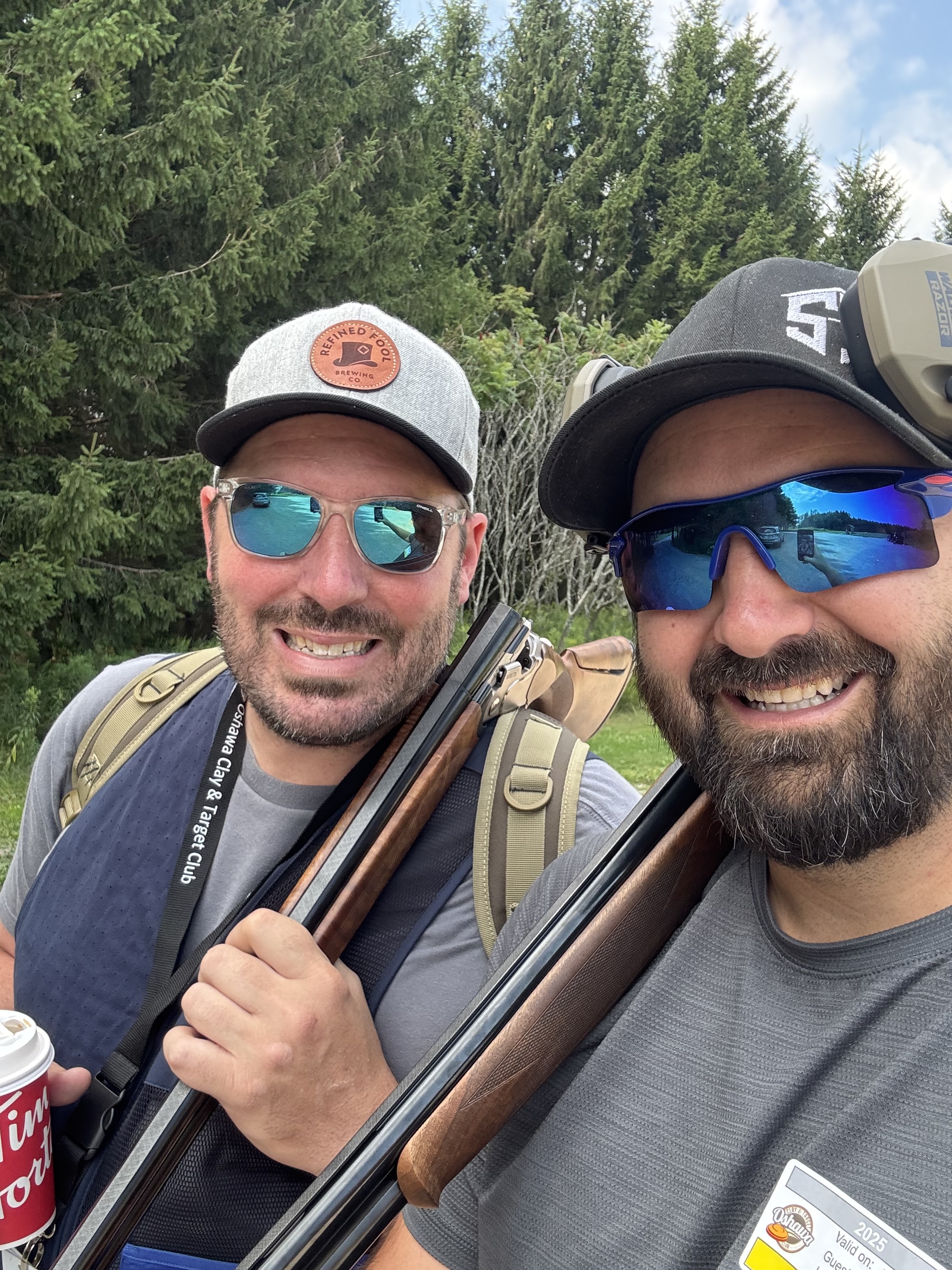 Two friends smiling after a good round at the range